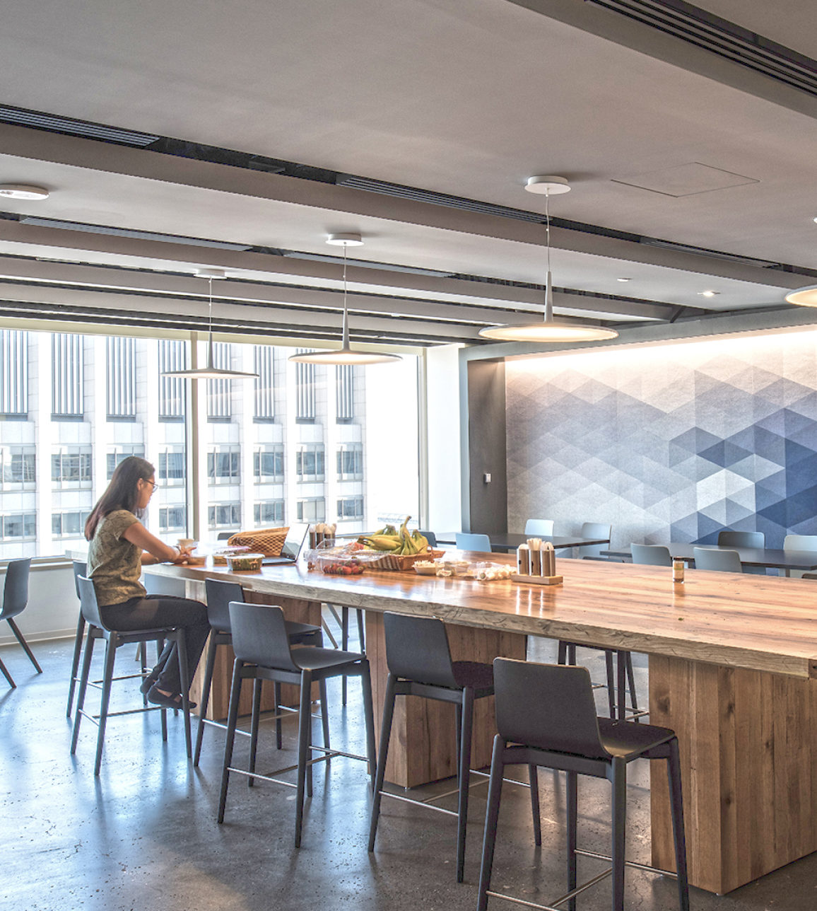 Tenant employee eating at table inside 45 Fremont building