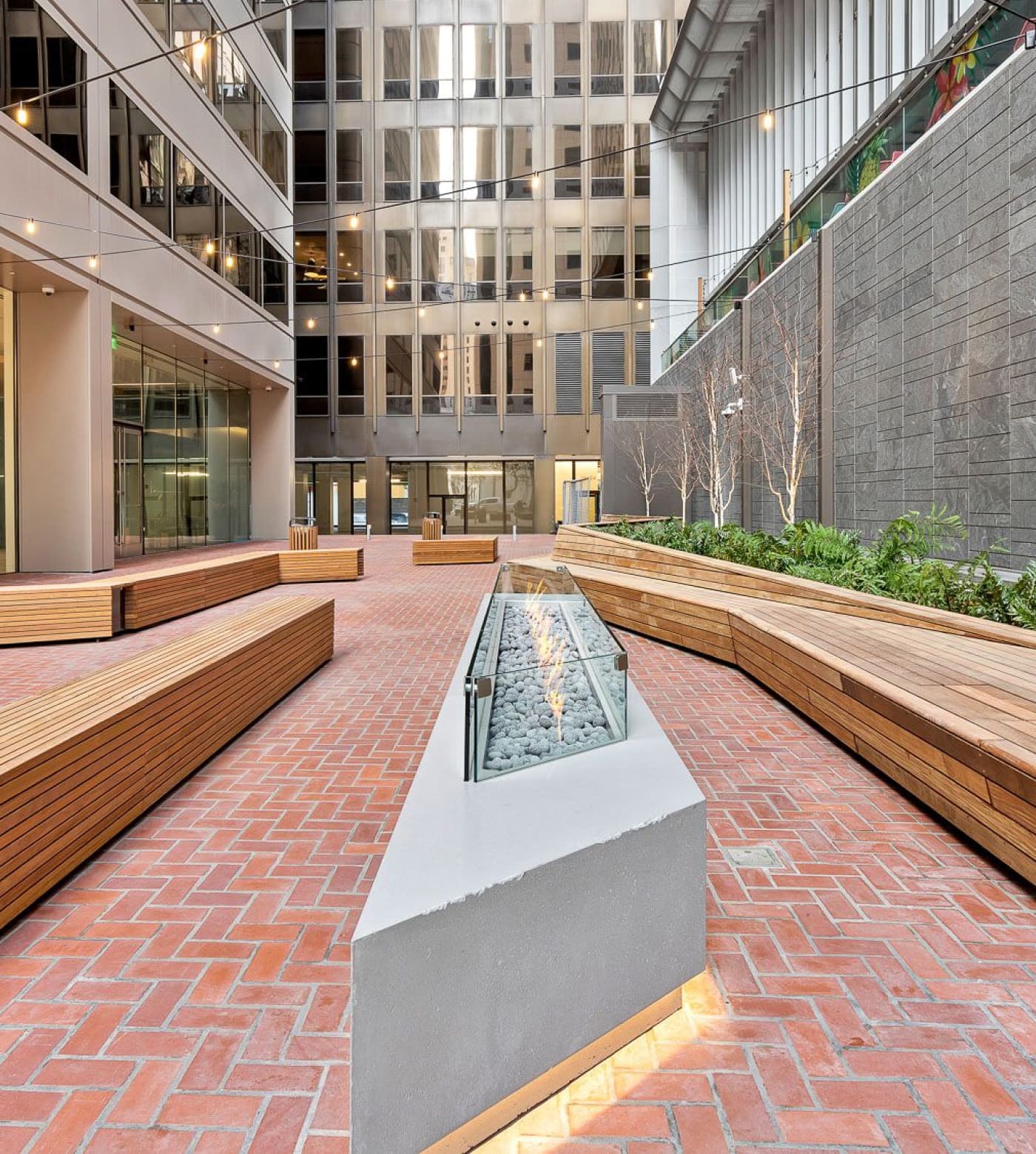 A view of the 45 Fremont outdoor courtyard with fire pit and benches